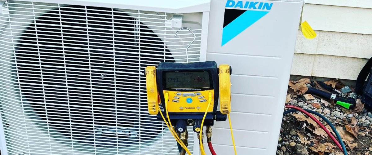 A Daikin outdoor heat pump being repaired